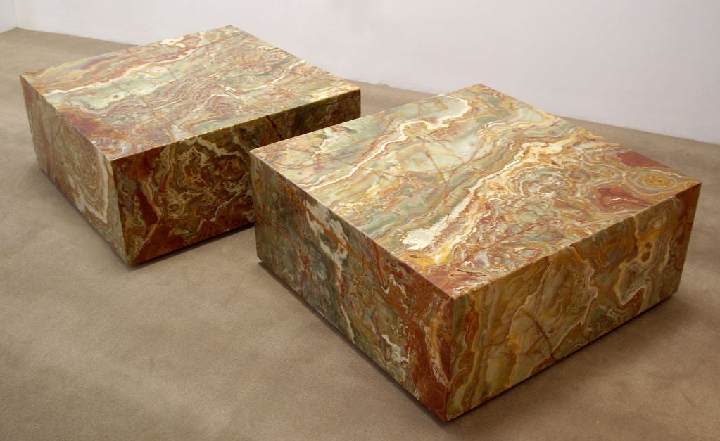 Pair of stone coffee tables constructed with onyx slabs. Features hidden wheels for easy moving. Price is for the pair.