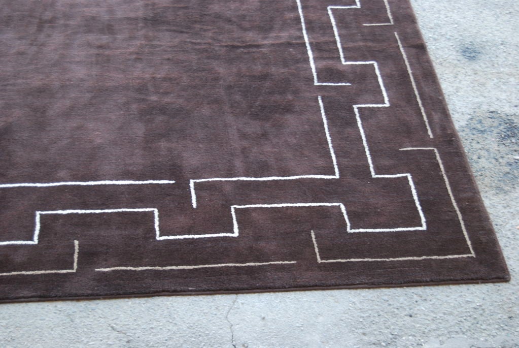 A gorgeous and large custom rug by the desert's most celebrated designer. Chocolate brown with a beige and white geometric border. Measuring at a massive 14.5 feet by 15 feet!<br />
Located in our Palm Springs warehouse.