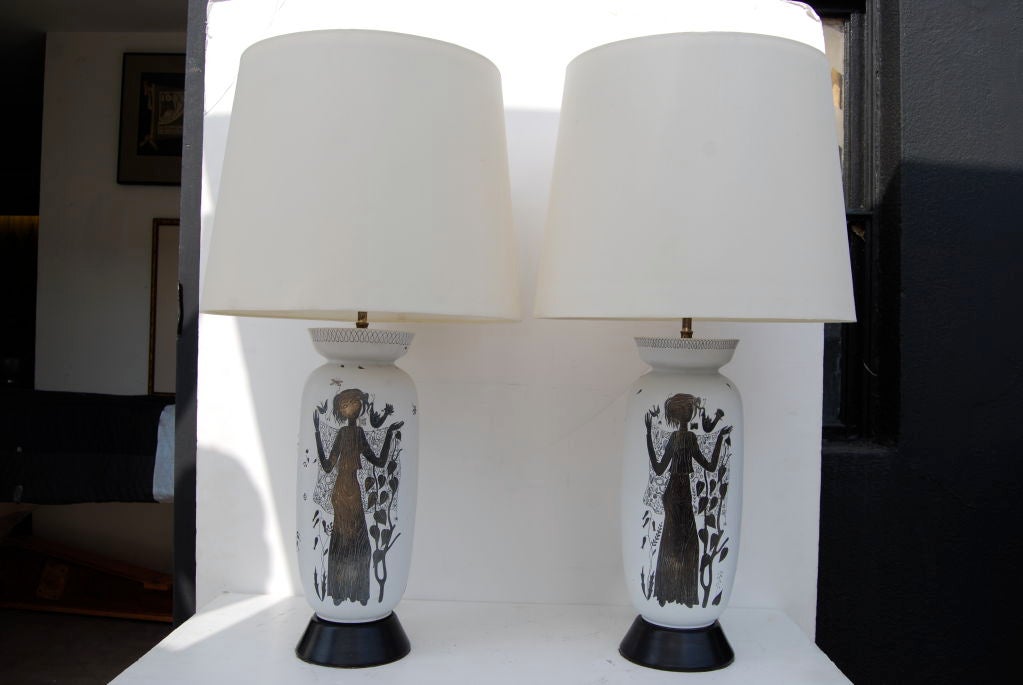 A fantastic pair of lamps custom made by Paul Laszlo for a Bel Air Estate. This visionary designer chose a pair of silver overlay vases by Stig Lindberg for Gustavsberg, as the central element of these lamps. They also feature silver plated hardware