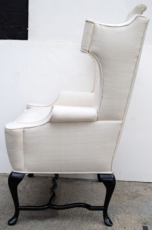 A really fun Arturo Pani wing chair. Restored in a Van Dyke finish on the legs and upholstered in an off-white tussah silk. 
Documented in 