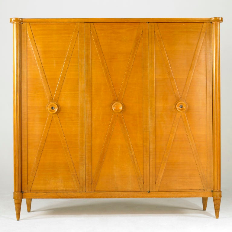 A wonderful Sornay armoire in sycamore and featuring Sornay's signature copper nail head detail.