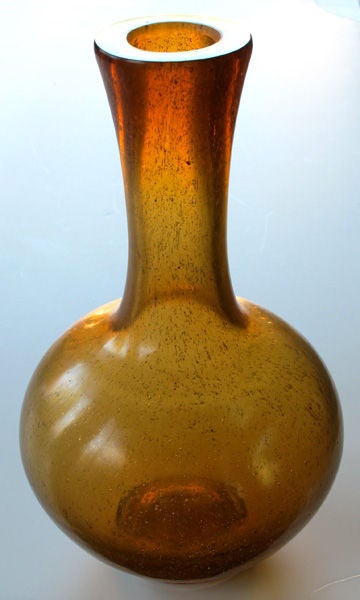 An unusually large Chinese Qianlong style amber-colored Peking glass bottle-form vase; with honorific mark to recessed base; the large-scaled vase with long flaring neck above a bulbous body all in a deep amber glass with gold inclusions