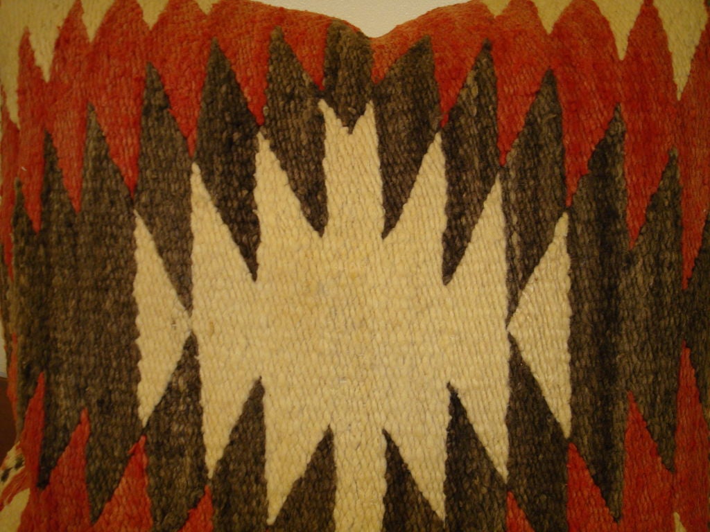 1930'S NAVAJO WEAVING PILLOW W/HOMESPUN LINEN BACKING.RED,GREY,CREAM GROUND.THE ENDS HAVE A INTERESTING WEAVING PATTERN.THERE IS ONLY ONE OF THIS PATTERN PILLOW.