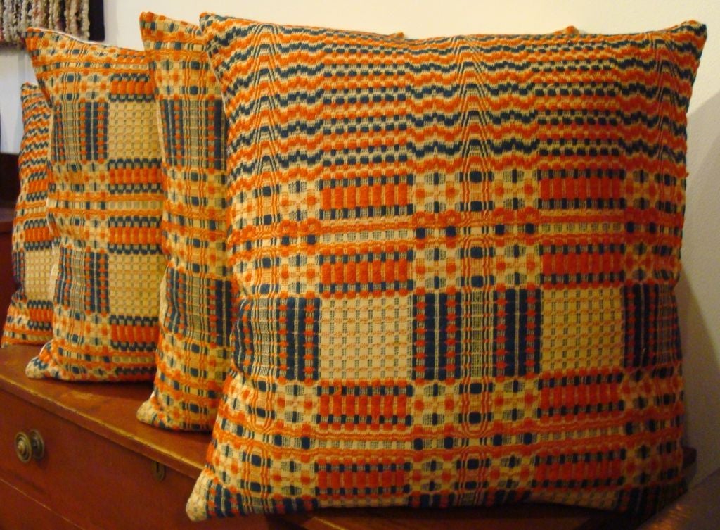 COVERLET PILLOWS IN ORANGE, BLUE, AND BEIGE. BACKING IS A HOMESPUN. ZIPPERED W/ FEATHER AND DOWN INSERTS. 395 EACH