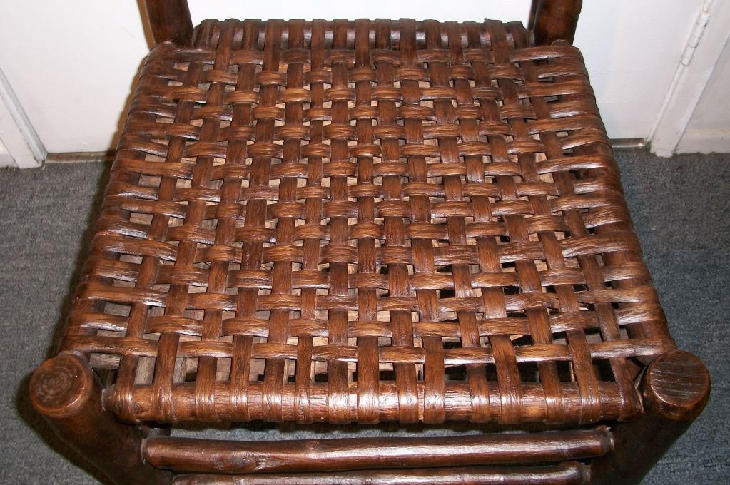 RUSTIC OLD HICKORY SIDE CHAIR W/HAND WOVEN SPLINT HICKORY SEAT. WONDERFUL OLD FINISH AND CONDITION IS GOOD. THIS CHAIR IS FROM THE OLD HICKORY CHAIR CO. IN MARTISVILLE, INDIANA.