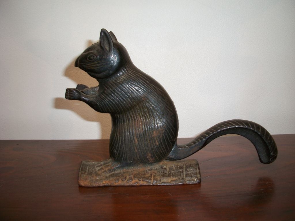 19TH C. IRON SQUIRREL NUT CRACKER. THE TAIL MOVES UP AND DOWN TO CRACK THE NUTS IN SQUIRRELS MOUTH.