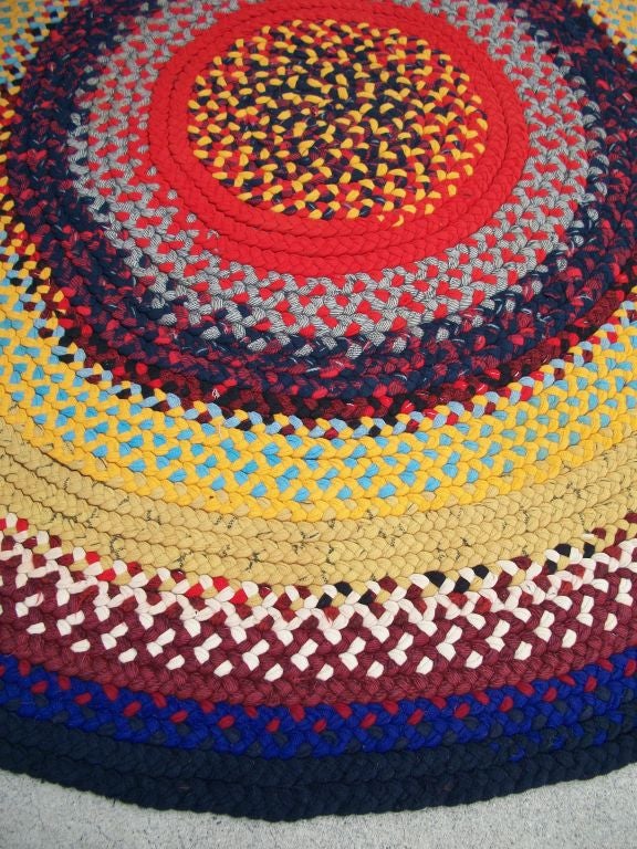 THIS COLORFUL ROUND BRAIDED RUG IS IN GREAT CONDITION. THE COLORS ARE RED, YELLOW, TURQ., ROYAL BLUE W/A BLACK BORDER.