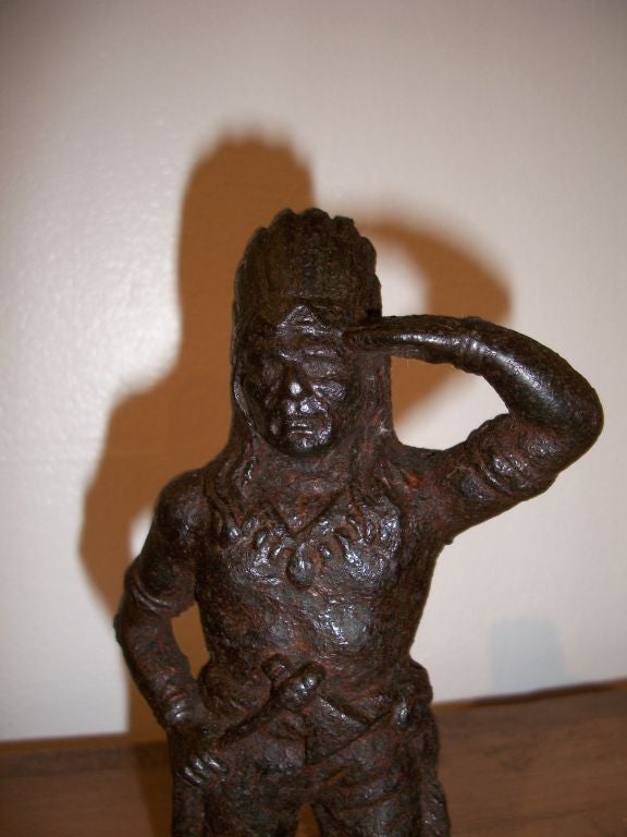 19TH C. CAST IRON STANDING INDIAN CHIEF BANK. DRESSED WITH FULL HEAD DRESS. WONDERFUL WARM PATINA.