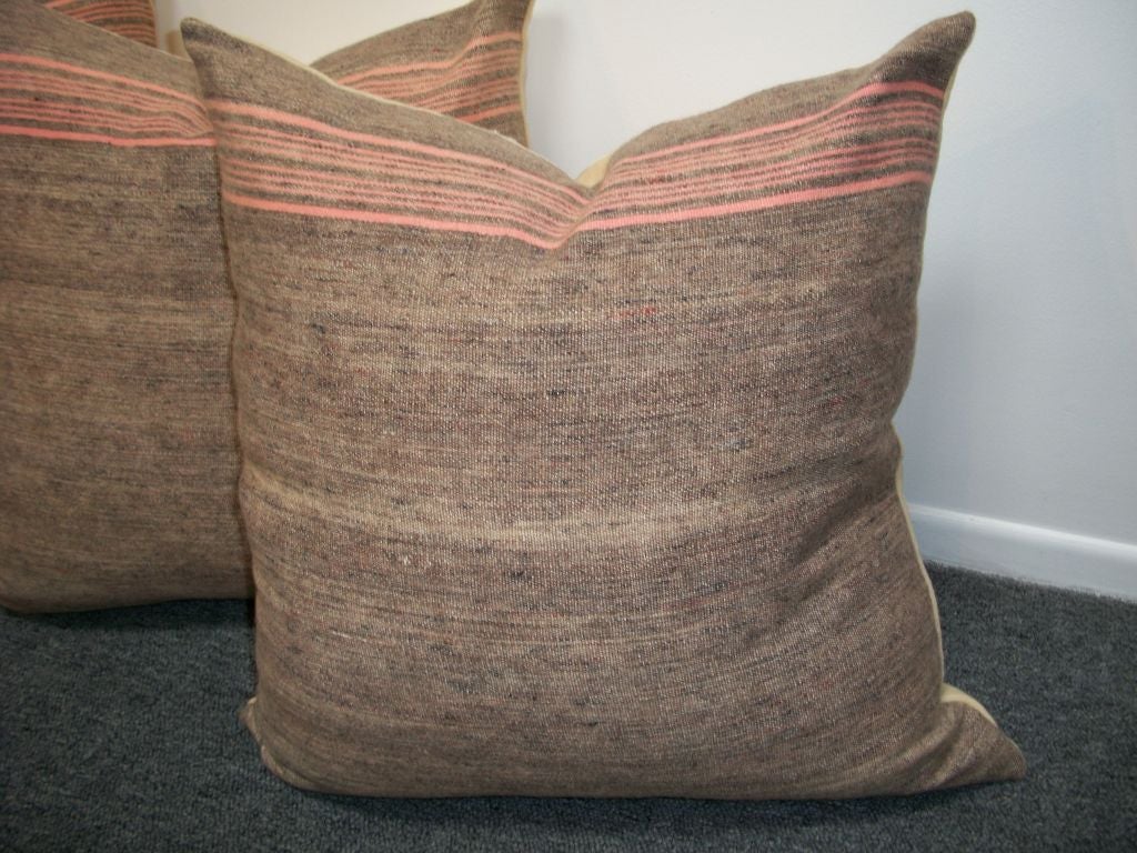 VINTAGE WOOL BLANKET PILLOWS. BROWN WITH PINK STRIPES. BACKING IS FROM A VINTAGE CREAM WOOL BALNKET. PILLOWS HAVE ZIPPERS AND FEATHER AND DOWN INSERTS. 395 EACH