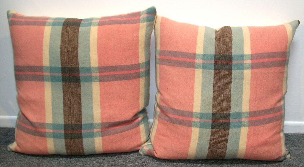 20TH C.PLAID WOOL BLANKET PILLOWS IN PINK, BLUE, CREAM AND BROWN. THE BACKING IS A VINTAGE WOOL BLANKET, CREAM ON 2 OF THE SMALL PILLOWS, AND CREAM AND PINK STRIPE ON 2 LG PILLOWS. THERE ARE TWO 24 X 24 395 EACH AND TWO 18 X 18 $325 EACH