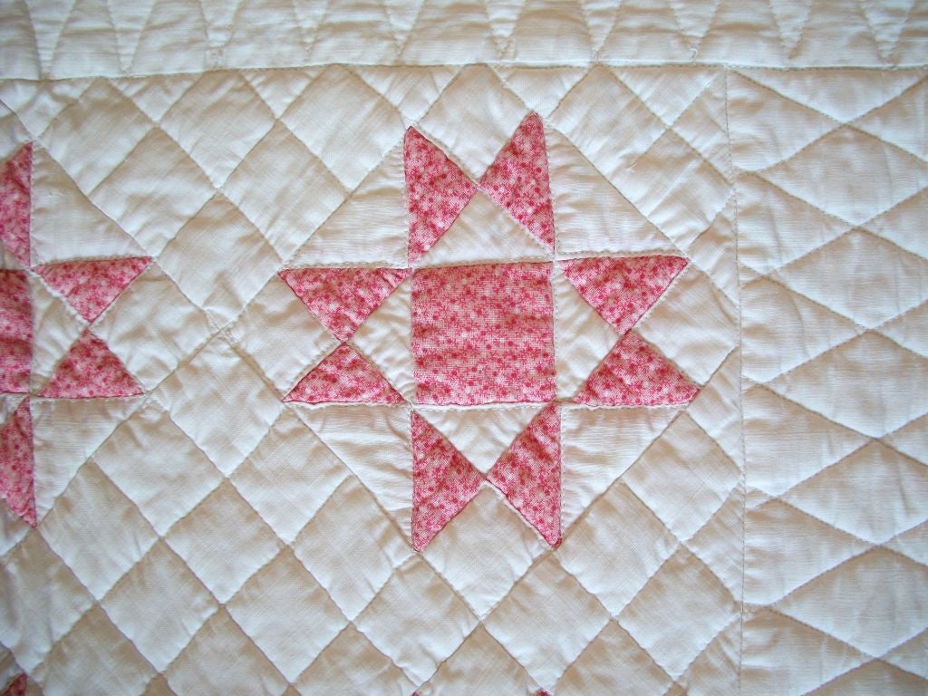 This finely pieced eight point star crib quilt is in pristine condition. The body of the quilt is treadle machine quilting and is a common thing done in the 19th century for crib quilts. This was done to keep the crib quilts in good condition and