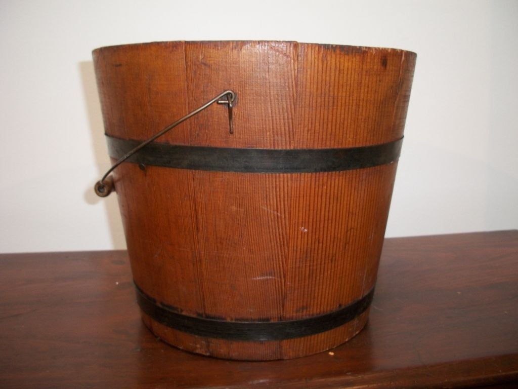 19TH C. WATER BUCKET W/ORIGINAL HANDLE. REINFORCED WITH METAL BANDS.