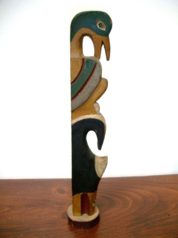 EARLY 20THC INDIAN HAND CARVED & PAINTED TOTEM POLE IN POLYCHROME PAINT ON ITS ORIGINAL STAND. GREAT FORM AND COLORS. THIS IS FROM A PRIVATE COLLECTION IN SANTA FE, NEW MEXICO.