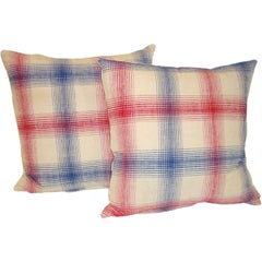 19TH C. LINEN PLAID PILLOWS IN RED, WHITE, AND BLUE.