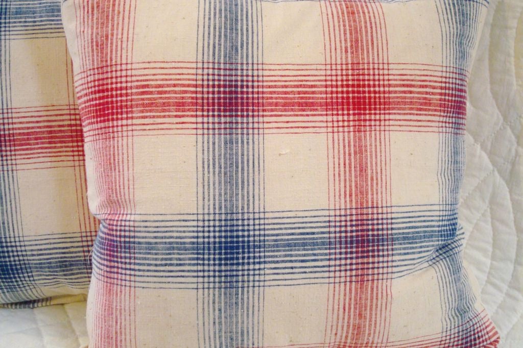 LINEN PLAID PILLOWS IN RED, WHITE, AND BLUE. BACKING A NATRAL HOMESPUN. ZIPPERED W/ FEATHER AND DOWN INSERT. 295 EACH