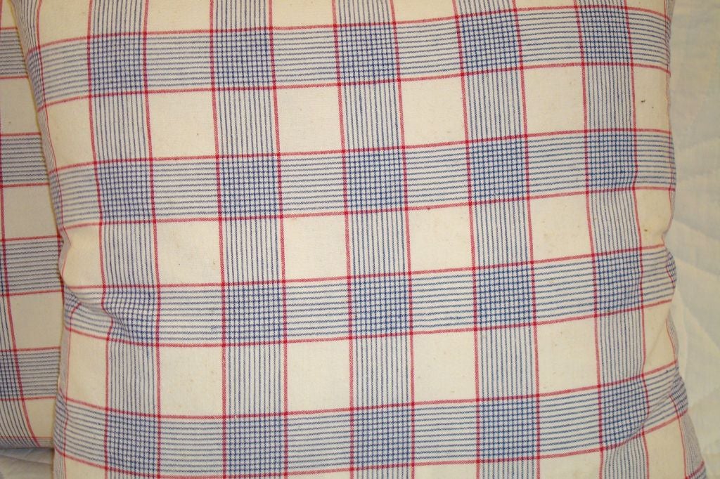 LINEN PLAID PILLOWS IN  RED, WHITE, AND BLUE. NATURAL HOMESPUN BACKING. ZIPPERED, AND FEATHER AND DOWN INSERT. 295 EACH