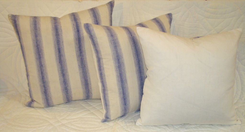 American 19TH C. LINEN STRIPED PILLOWS IN BLUE, AND WHITE.
