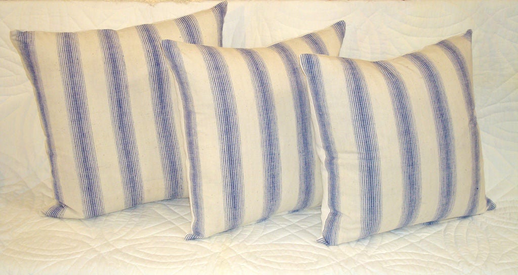 LINEN STRIPED PILLOWS IN BLUE, AND WHITE. BACKING A NATURAL HOMESPUN ZIPPERED AND DOWN AND FEATHER INSERTS. 295 EACH