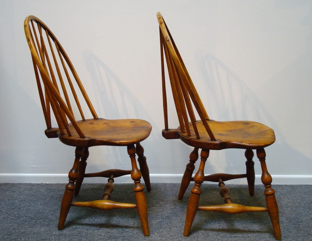 THIS BEAUTIFUL MATCHING PAIR OF AMERICAN 18TH C BRACE BACK WINDSOR NEW ENGLAND CHAIRS. THIS SET OF CHAIRS HAVE NINE SPINDLES AND SADDLE SEATS WITH NICE PLANK SEATS. THE LEGS HAVE FANTASTIC TURNINGS AND VERY NICE SPLAY. THE SURFACE IS A OLD NATURAL