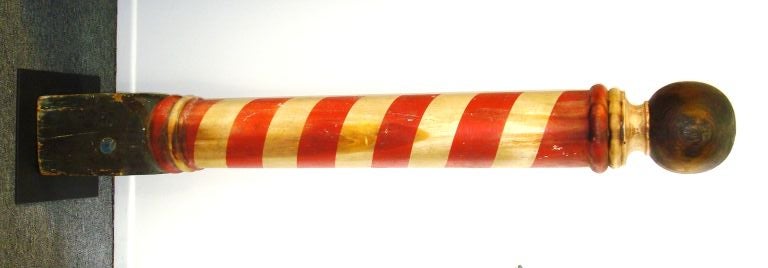 THIS BARBER POLE IS ALL ORIGINAL PAINT WITH A GILDED BALL ON TOP. THE POLE IS RED AND WHITE WITH A BLUE BLOCK BASE. THE PAINT IS FANTASTIC AND HAS A WONDERFUL PATINA. THE POLE SITS ON A CUSTOM MADE CAST IRON MOUNT. THIS BARBER POLE IS FROM A PRIVATE
