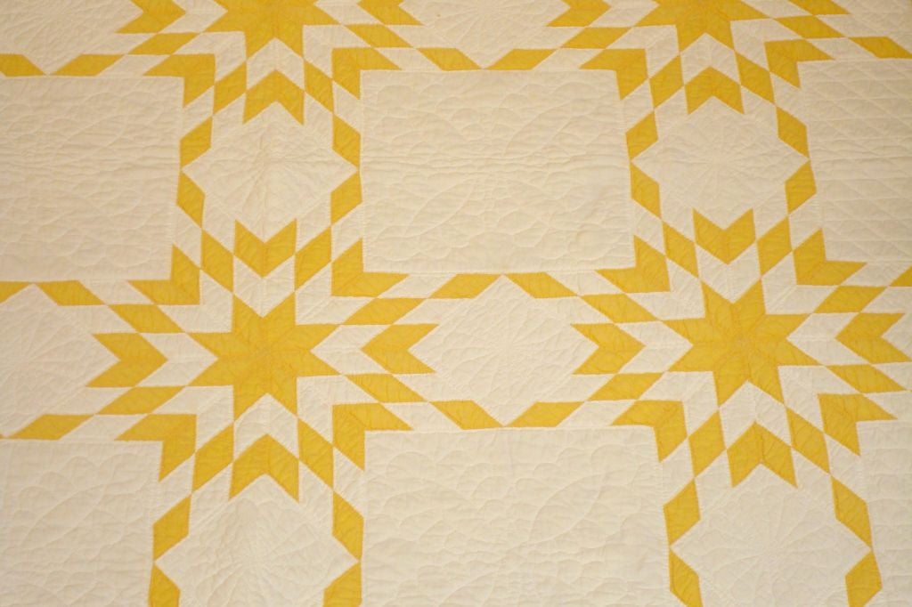 PAIR OF MATCHING TWIN BED QUILTS IN MUSTARD YELLOW. THIS PAIR OF TOUCHING STAR QUILTS ARE FROM PENNSYLVANIA AND IN GOOD CONDITION. SOLD ONLY AS A PAIR FOR $1850.