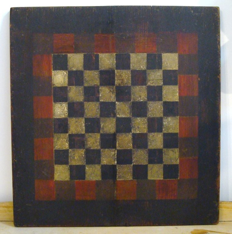 ORIGINAL PAINTED REVERSIBLE CHECKERBOARD IN A BLACK AND WHITE WITH GREAT PATINA.  THE REVERSIBLE SIDE IS A PARCHEESI GAMEBOARD. REDISH BROWN, BLACK AND YELLOW ALSO WITH GREAT PATINA.