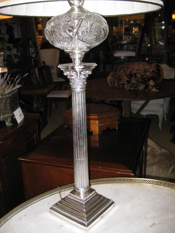 Classic lamp in sterling silver with crystal font and weighted base and stem.