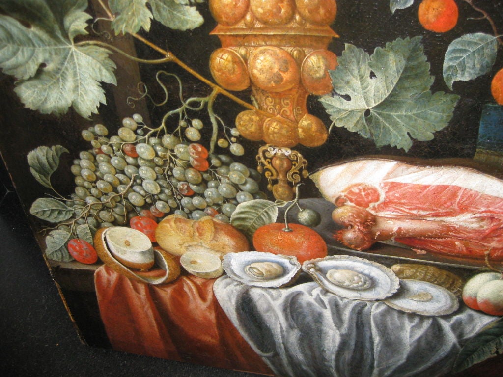 Large Still Life with a variety of fruit, meat, and oysters, glass of wine, and silver Chalice.  This is a very rare work and the signature can be seen in image 6.  There is a frame that it was found in which is not of the period.