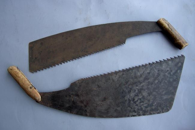 Two 19th c. hand saws with wooden handles. Markings on metal. Great patina. Sold separately. Measurements are 10