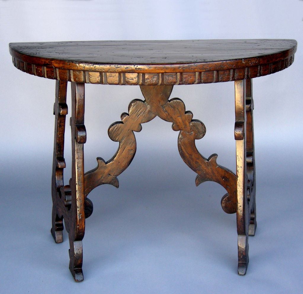 Custom Alder demi lune table with lyre legs and carved stretchers. As shown heavily distressed with a medium-dark walnut finish. Can be made in custom finishes and and sizes, in Walnut, Oak or Mahogany. Bench made in Los Angeles by Dos Gallos