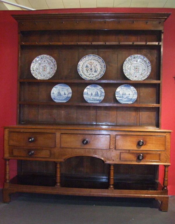 Very fine early 19th century welsh dresser, the open rack retaining original brass hooks over shelves and original wide beaded edge backboards, the base with three large over two smaller drawers all retaining original rosewood and mother of pearl