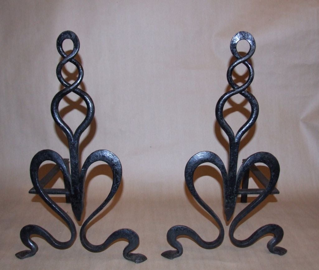 Rare pair of English Arts and Crafts wrought iron andirons and matching fire tools in loop twist design.