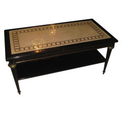 Jansen style ebonized leather-top coffee table on fluted legs