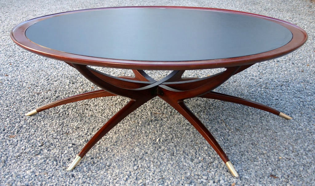 Walnut collapsible coffee table with brass sabots and burnished black leather top.