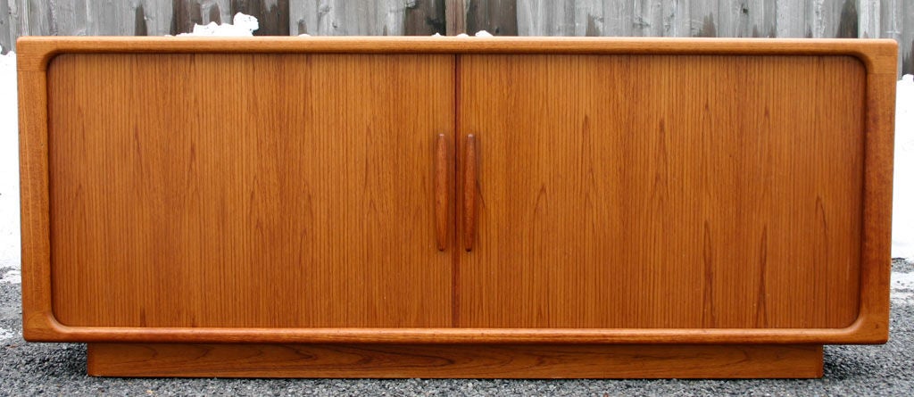 Magnificent teak tambour sideboard with with wood handles, and interior drawers and shelves; by Dyrlund, Denmark. Top display piece also available (see pics).