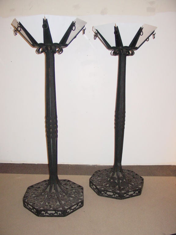 each with an octagonal shade fitted with eight white slag glass panels above a swelling standard applied with rosettes on a spreading octagonal similarly decorated foot