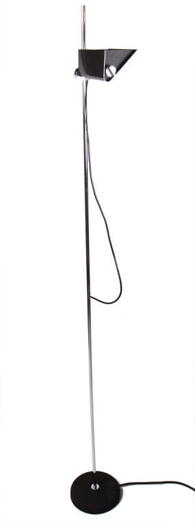 A tall floor lamp with a swiveling triangular uplight that slides along a polished chrome pole to adjust light closer to or further away from the ceiling. By Arredoluce, Italian, circa 1970s.