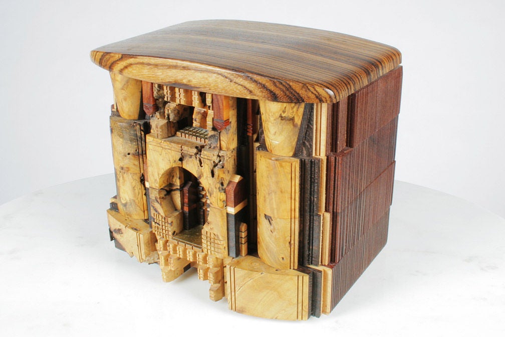 A fantastic, one-of-a-kind jewelry box made from an assortment of hand-carved woods that were exquisitely constructed into an architectural building fitted with six pivoting compartments. Po Shun's art boxes are featured in such museums as the Los