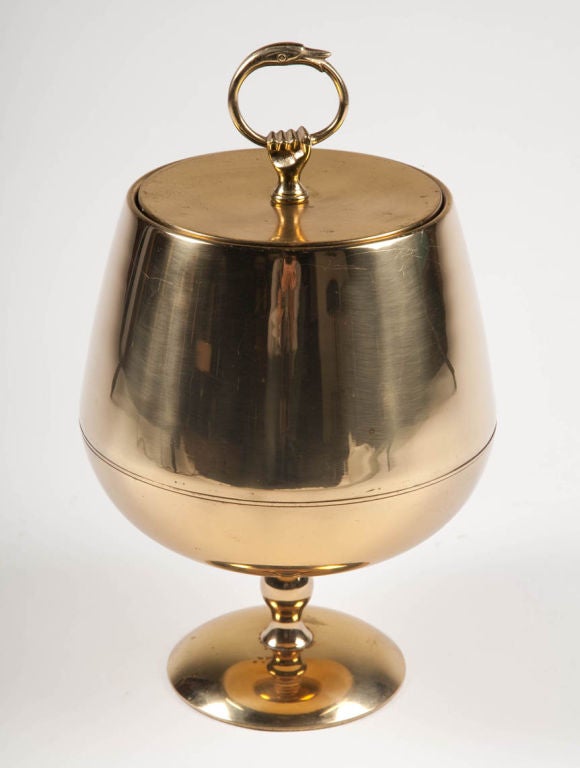 An chalice-formed ice bucket having a top with a ringed handle in the shape of a duck head then held by a brass hand.  Marked “Made in Italy”. After Aldo Tura. Italian, circa 1970.