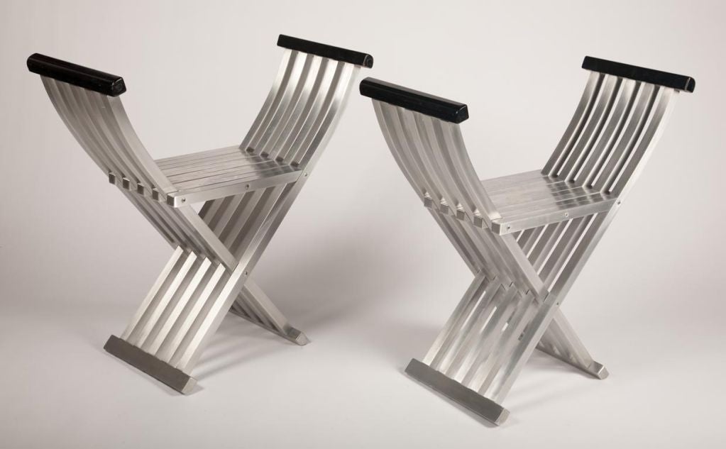 A pair of folding chair benches in brushed aluminum designed with precision engineering for a sleek look and finely crafted seat. By John Vesey. American, circa 1959. Overall height: 27 1/4