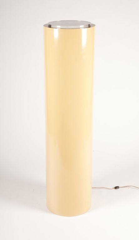 A Space Age pair of lighted pedestal display columns. This unique pair consists of tall cylindrical forms of fiberglass in pale yellow with a circular Lucite disc inset to the top and an interior light that shines through it. After Pace. U.S.A.,