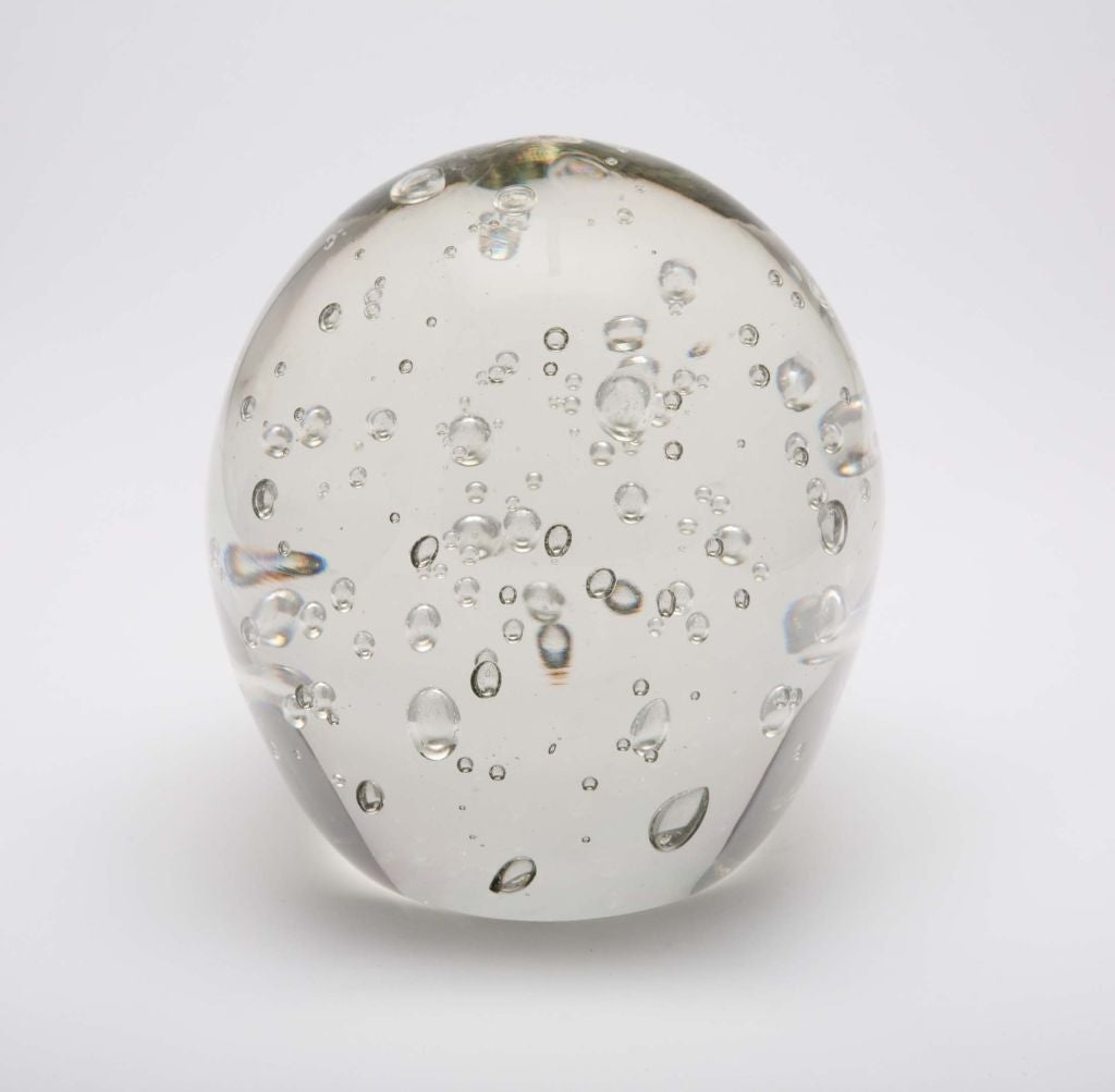A glass object or large paperweight in solid clear glass with controlled air bubbles that float within its egg shape. Has original label “Kaiser Krystal Hand-Cut Made in Argentina”, and incised edition numbers “328/6”. By Kaiser Krystal. Argentina,