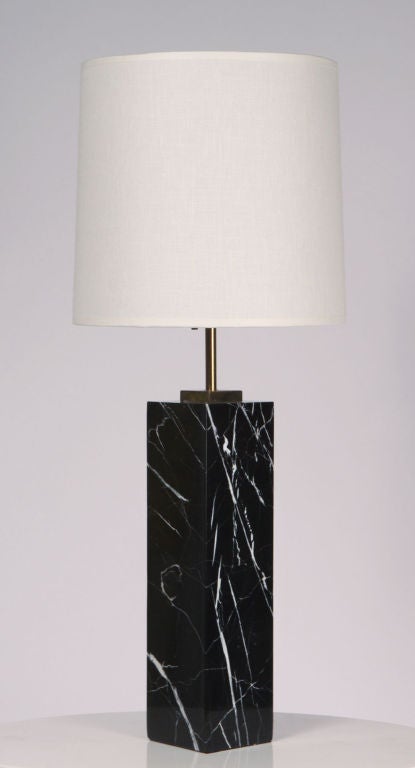 An elegant column formed table lamp with an exquisite black Marquina marble body and sumptuous white veining throughout fitted with polished brass riser and fittings. Designed by T.H. Robsjohn-Gibbings for Hansen, NYC. U.S.A., circa 1950.