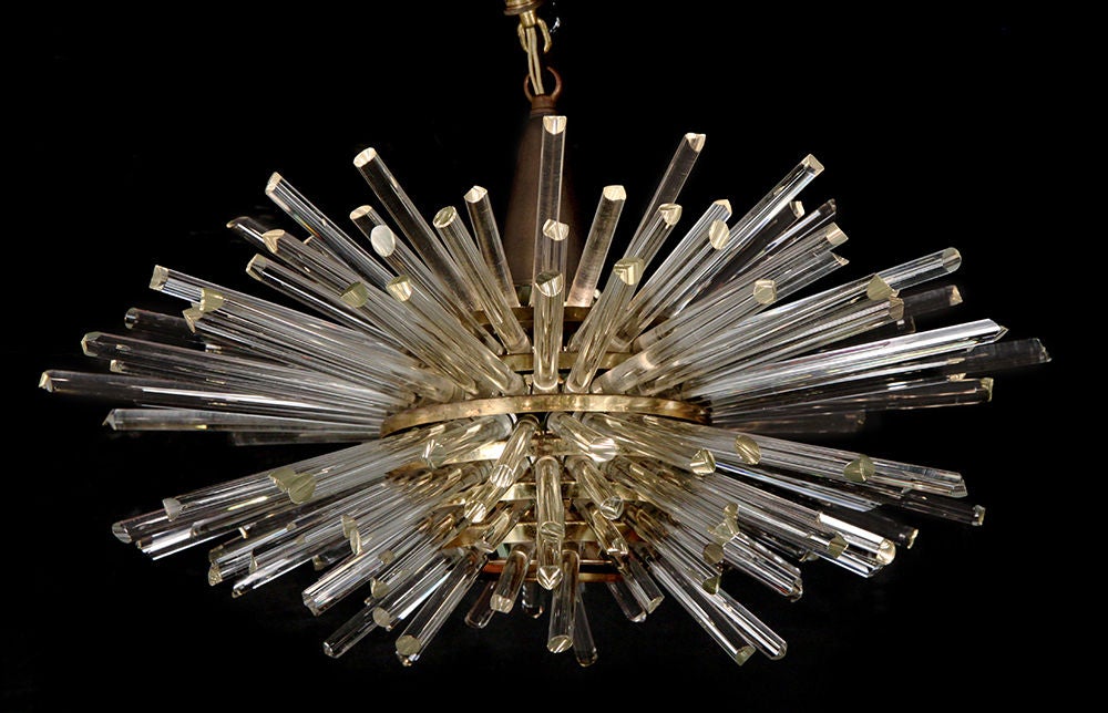 A fantastically radiant 'Miracle' chandelier comprising clear glass rods set between open slats of a spherical body in brass creating a sputnik form.  Each rod carries the light outward. By Bakalowits and Sohne. Austrian, circa 1960.