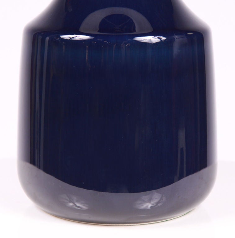 A beautiful, tall ceramic table lamp with a long tapering neck forming into a round jug shaped body all in a high gloss cobalt blue glaze.  By Lotte Bostlund. Canadian, circa 1950.