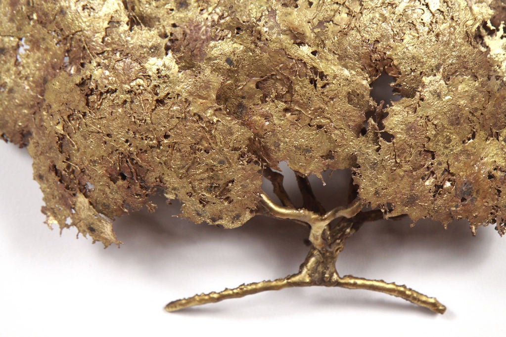 A delicate and petite wall sculpture in the form of a large, billowing oak tree, finished in gilt bronze and signed to the lower right “Bell”. American, circa 1950.