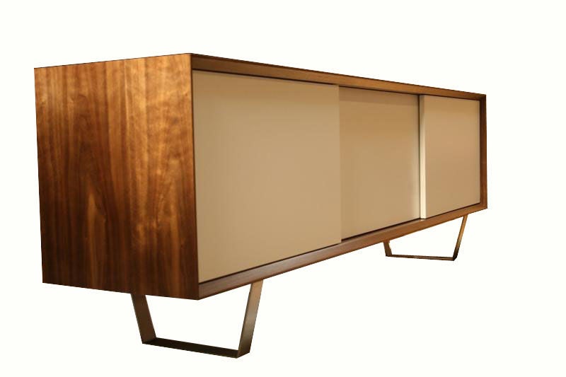 Mn Originals three-door Walnut credenza on polished stainless steel base. Active grain walnut Veneer case contrasted with satin lacquer white sliding door fronts.Interior has three separate units, each with it's own adjustable shelf and interior