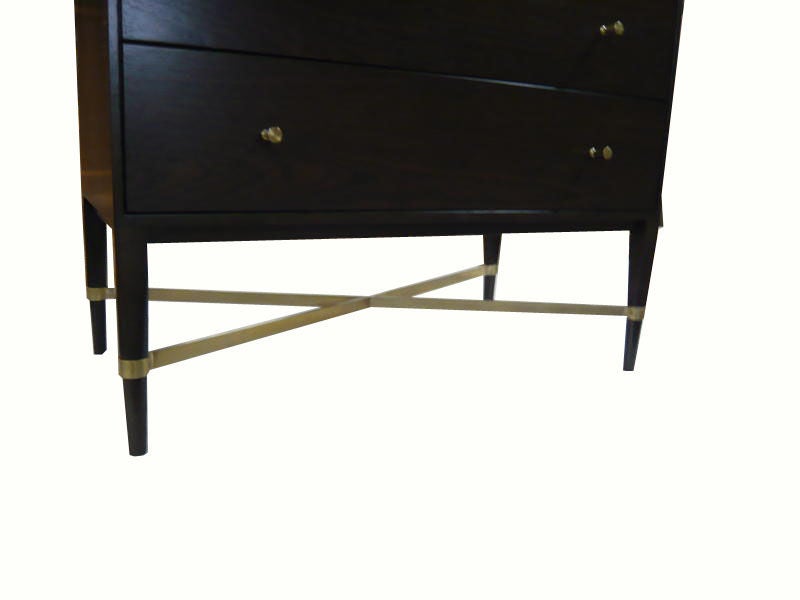 Five-drawer mahogany commode on solid tapered legs detailed with a X flat-bar brass stretcher. Dark walnut toned mahogany construction contrasted with polished brass hardware.

Custom orders have a lead time of 10-12 weeks FOB NYC. Lead time