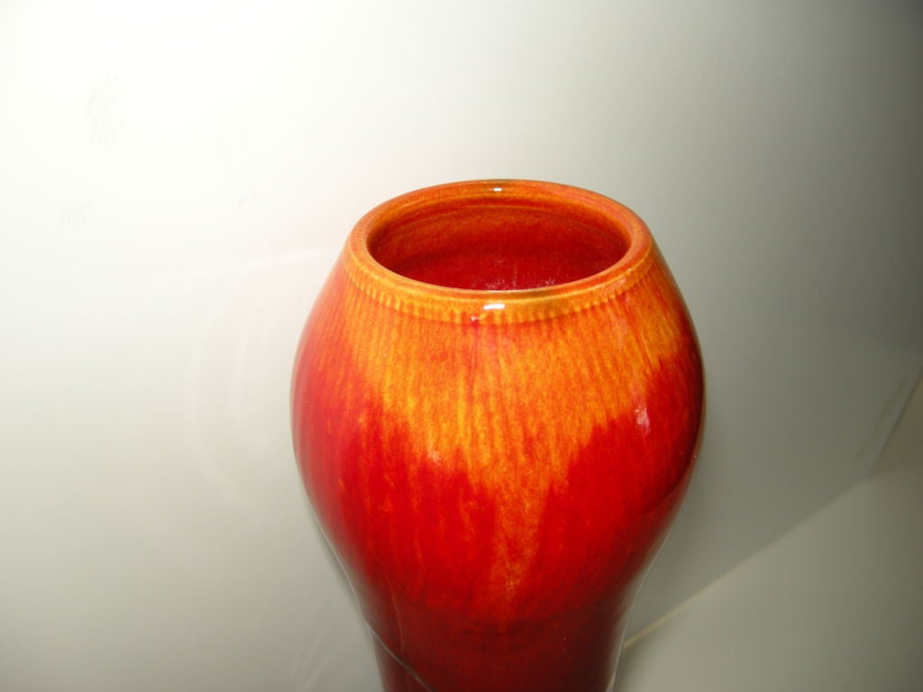 A vibrant and sculptural form in this unusual tall hand thrown, and hand painted vase.