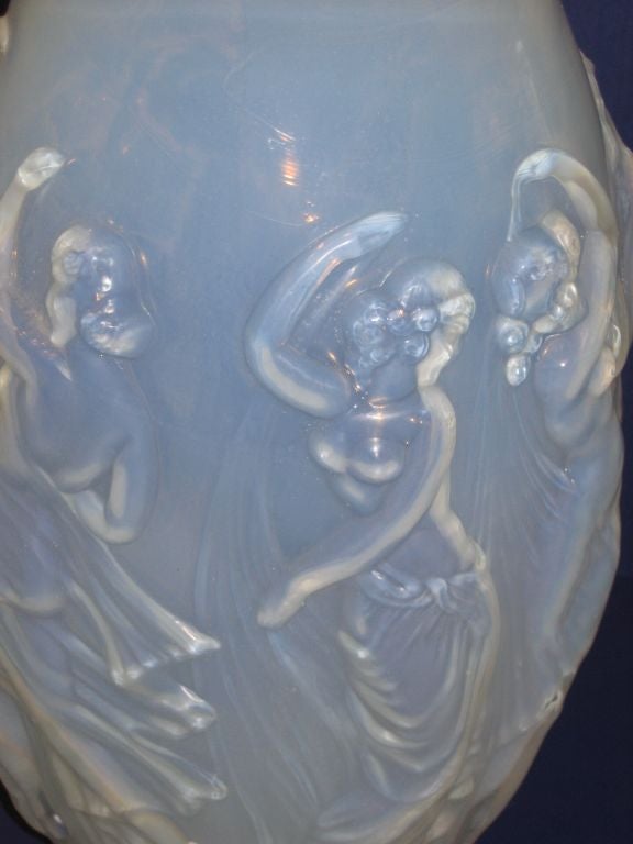 Standing a magestic 14' in height,this Sabino vase displays an array of Art Nouveau style female forms engaged in dance.The glass is an excellent example of the blue hued opalescent and iridescent work that Ernest Sabino is known for.